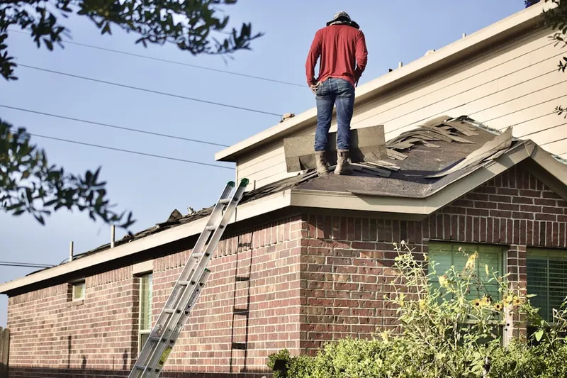 Professional roofer working on a residential roof in Deerfield Estates